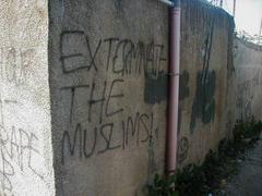 Graffiti on the walls surrounding Kawther's home