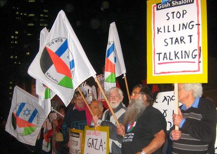 Gush Shalom activists with the movement's flags