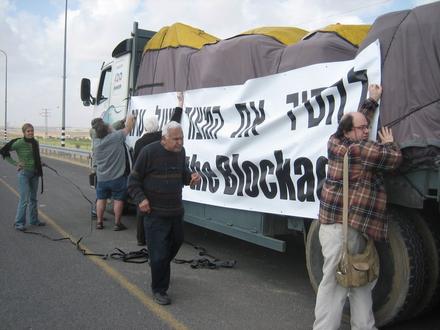 Yaacov Manor, one of the organizers of the action, supervises the hanging of the political slogan on the supplies