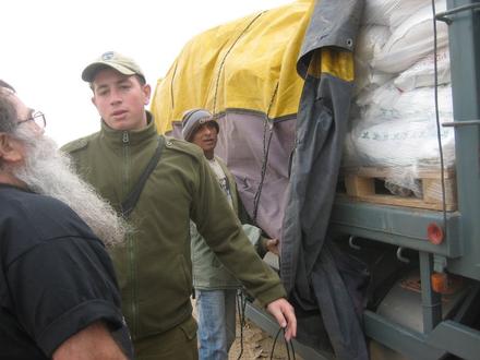 A soldier (in the middle) checks the supplies with Teddy Katz  at Sofa gate