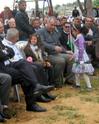 Two small girls insist on sitting next to the Prime Minister after giving him a rose..
