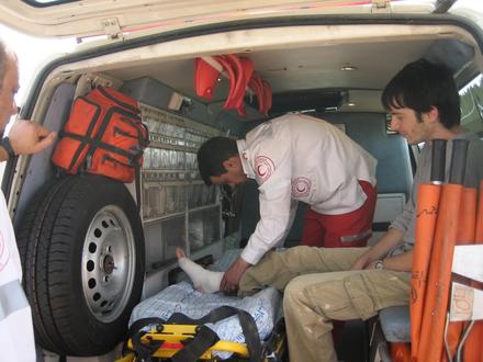 Protester wounded in the leg is bandaged in Palestinian ambulance