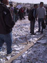 Demonstrators amongst rubble of shattered fake wall
