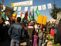 Posters and flags of all parties: the green of Hamas (right) and the Israeli flag on the Gush poster (left) 