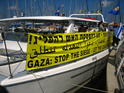 The boat is ready to sail with the slogan "Gaza - Stop the Siege, Let the Cease-Fire Sail!"