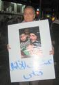 Protester carrying photo from Gaza. The caption in Arabic: “Dozens of Children Murdered!”