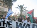 A demonstrator waving the flags of Israel and Palestine