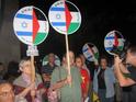 Protesters with Gush Shalom’s two-flag emblem